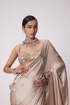 Beige Satin Saree Clubbed with Real Hand Cut Mirror Embroidered Sleeveless Blouse.From Vvani Vats Jugmug's collection.DELIVERY TIMEPlease allow 8-12 weeks for your outfit to arrive.FABRIC DETAILSSaree - SatinBlouse - GeorgetteProfessional cleaning only. Gold Satin Saree, Satin Sari, Mirror Blouse, Cut Mirror, Mirror Embroidery, Best Blouse Designs, Weddings Receptions, Indian Dresses Traditional, Satin Saree
