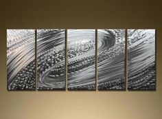 a large metal wall art piece with silver paint on it