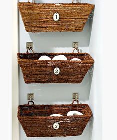 three baskets are hanging on the wall