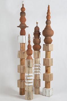 several wooden objects are stacked on top of each other in order to form a sculpture