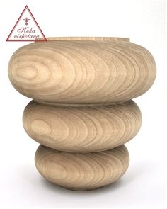 three stacked wooden objects sitting on top of each other in front of a white background