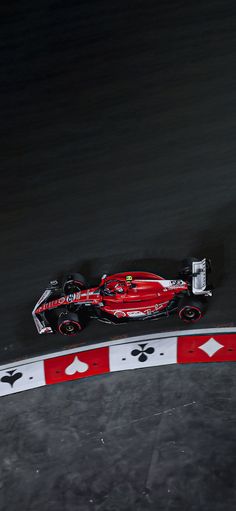 a man driving a race car on a track