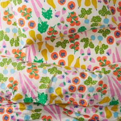 an image of a bed sheet with fruits and flowers on it