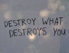 graffiti written on the side of a building that says destroy what destroys your life