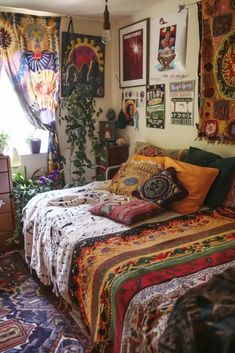 a bed room with a neatly made bed and many pictures on the wall above it