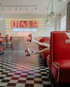 a woman in high heels is sitting on a checkered floor with her feet up