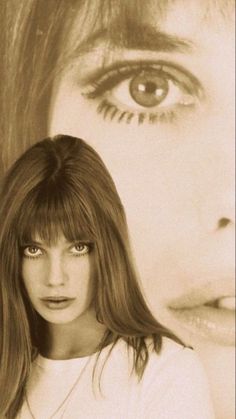 a woman with long hair and bangs standing in front of an image of her face