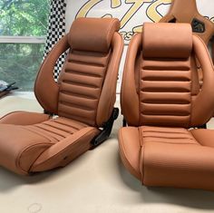 two tan leather seats sitting next to each other