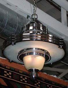 a light fixture hanging from the ceiling in a room with carpeted walls and ceilings