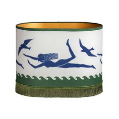 a white and green lamp shade with a woman swimming on the ocean in front of seagulls