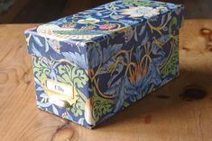 a blue and green box sitting on top of a wooden table