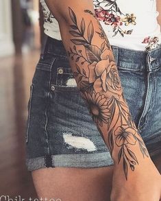 a woman with a flower tattoo on her arm