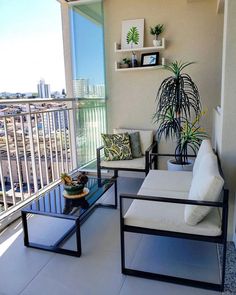 two chairs and a table on a balcony