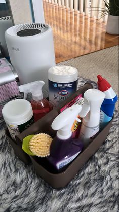 the contents of a hair care kit sit in a tray on a carpeted surface