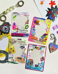 several different key chains and tags on a table