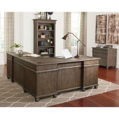 an office desk with bookshelf and bookcase