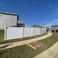 a white fence in front of some houses