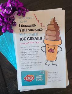 an ice cream advertisement with purple flowers on the table next to it and a blue envelope