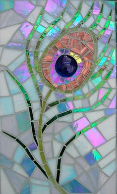 a stained glass mosaic with a flower in the center