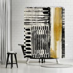 a black and white shower curtain next to a chair