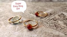 three gold rings sitting on top of a table with a speech bubble saying super easy ring diy