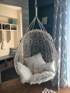 a white hanging chair in a living room