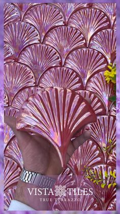 the back side of a woman's head in front of purple and yellow flowers