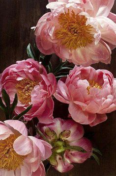 pink flowers are in a vase on a table