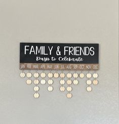 a family and friends sign hanging on the wall with lots of small discs attached to it