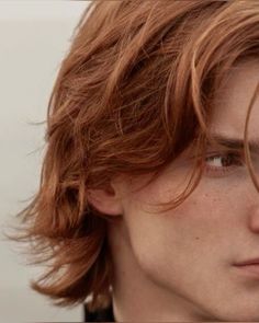 a close up of a person with red hair