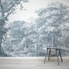 a chair sitting in front of a wall mural