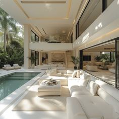 a living room with couches and tables next to a swimming pool