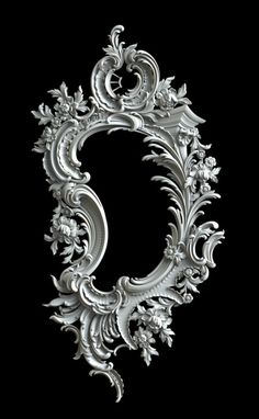 the letter c is made out of silver metal and has floral designs on it's sides