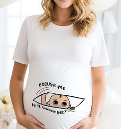 a pregnant woman wearing a white t - shirt with an image of a baby on it's belly