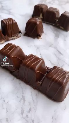 several pieces of chocolate sitting on top of a marble counter