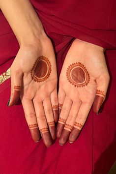 two hands with hendi designs on them, one is holding the other's hand