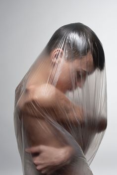 a man wrapped in plastic is posing for the camera