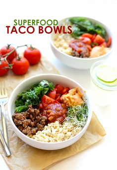 a white bowl filled with meat, rice and veggies on top of a table