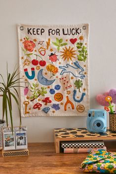 a wooden table topped with pictures and plants