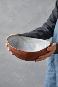 a person holding a bowl in their hand