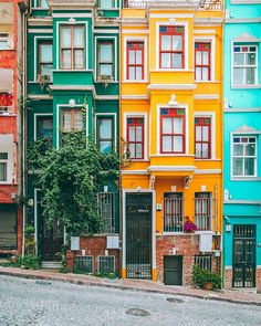several multicolored buildings line the side of a street