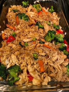 a glass dish filled with rice, broccoli and chicken