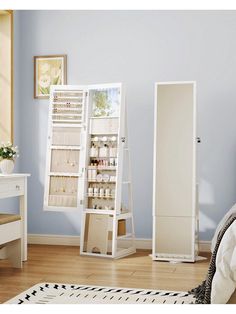 a bedroom with blue walls and white furniture