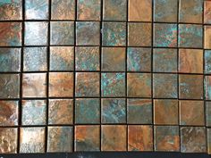 copper and blue tiles are arranged on top of each other