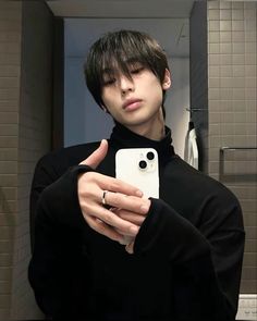 a young man taking a selfie in the bathroom