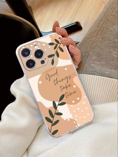 a woman holding up her phone case with the words good things take time on it