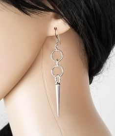 "Add some rocker chic to your ears with these long dangle spike and loop earrings. These super lightweight earrings are sure to get noticed!! 💀 DESCRIPTION: This pair of earrings were created with jump rings and silver spike charms. The earrings were attached to hypoallergenic stainless steel ear wires. 💀 SIZE & MATERIALS: The metal spikes measure approximately 1 1/4\" by 3/16\". They are made from a zinc alloy metal which is lead and nickel free. Overall, the earrings measure 2 5/8\" long Collares Dark, Spike Jewelry, Earrings Edgy, Spiked Jewelry, Emo Style, Earrings Punk, Metal Spikes, Jewelry Minimalist, Spike Earrings