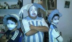 two young boys with their faces painted in blue and white are standing next to each other