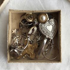 a box filled with lots of silver items