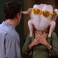 a man standing next to a woman in front of a fake pig wearing sunglasses on top of her head